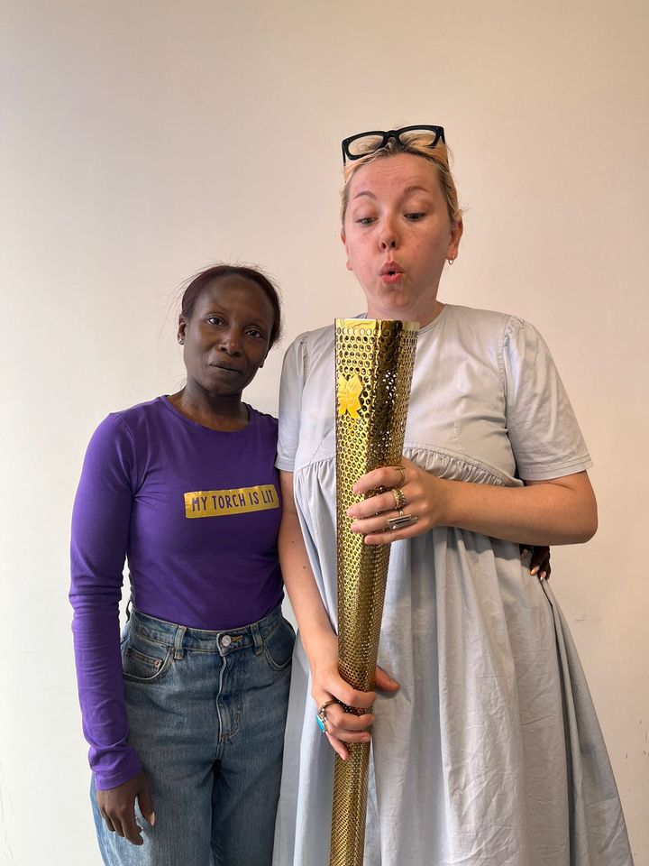 Image of Hannah and Workshop Leader holding Olympic Torch during the 'My Torch is Lit' Workshop.