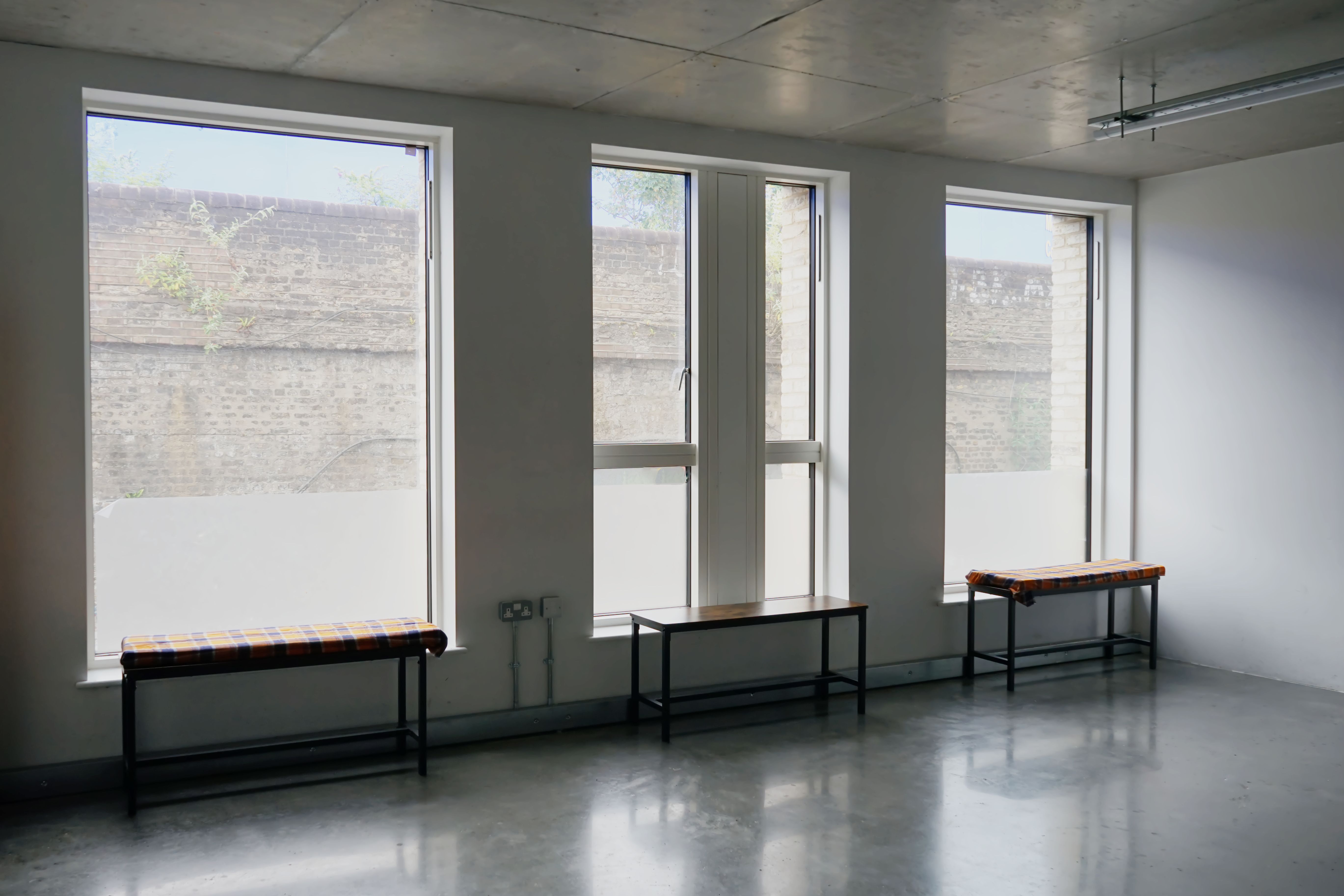 A large window with three benches in front of it