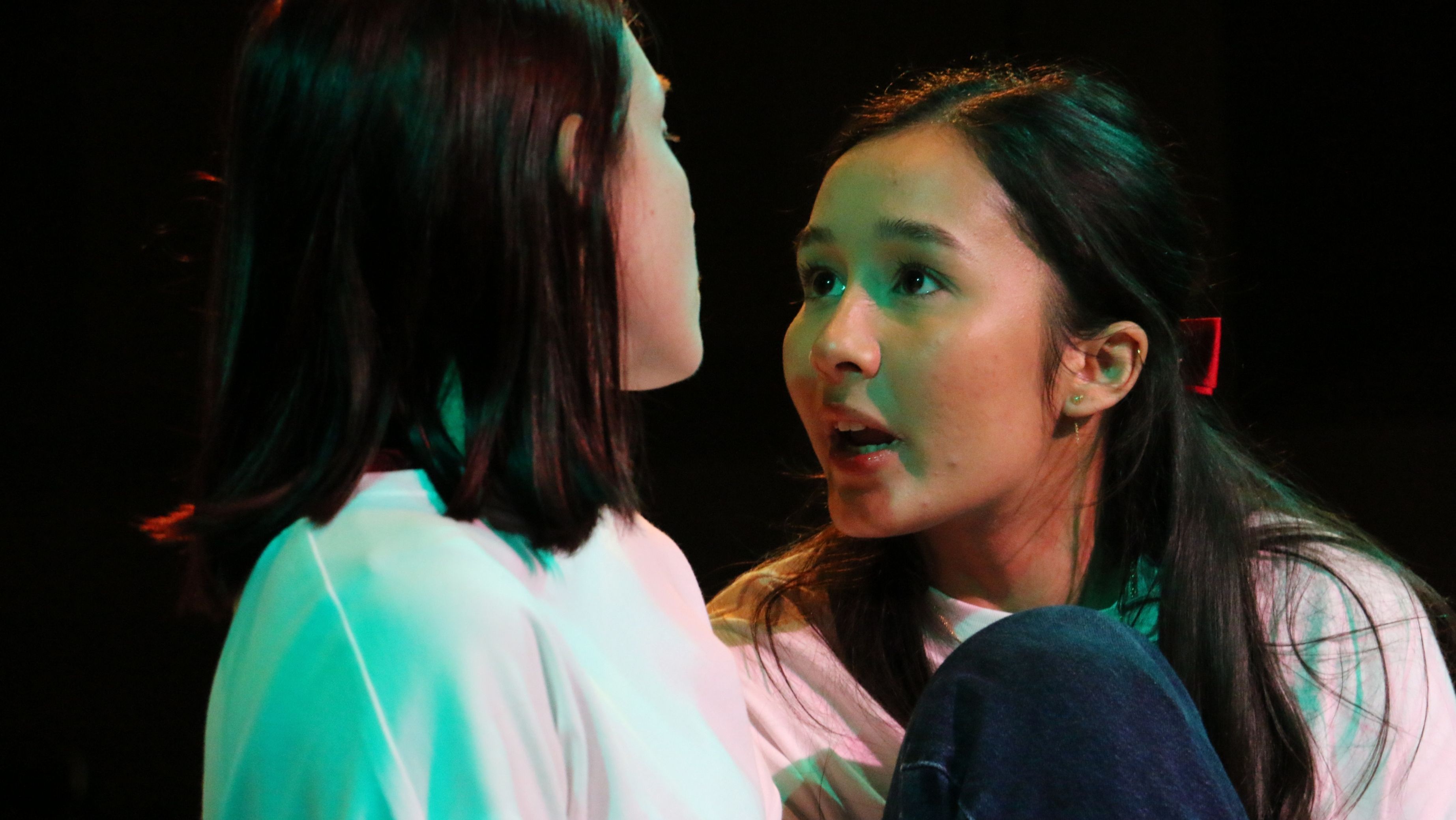 2 young women facing each other